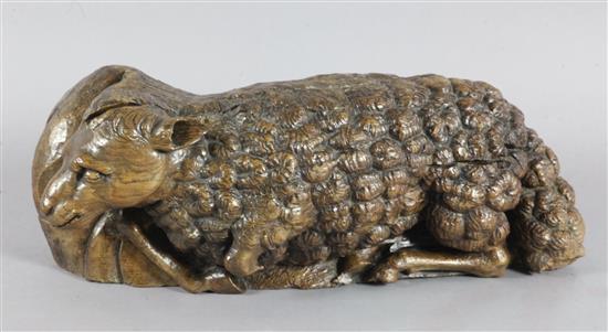 A 16th century Flemish oak deep relief figure of the recumbent lamb W.29in.